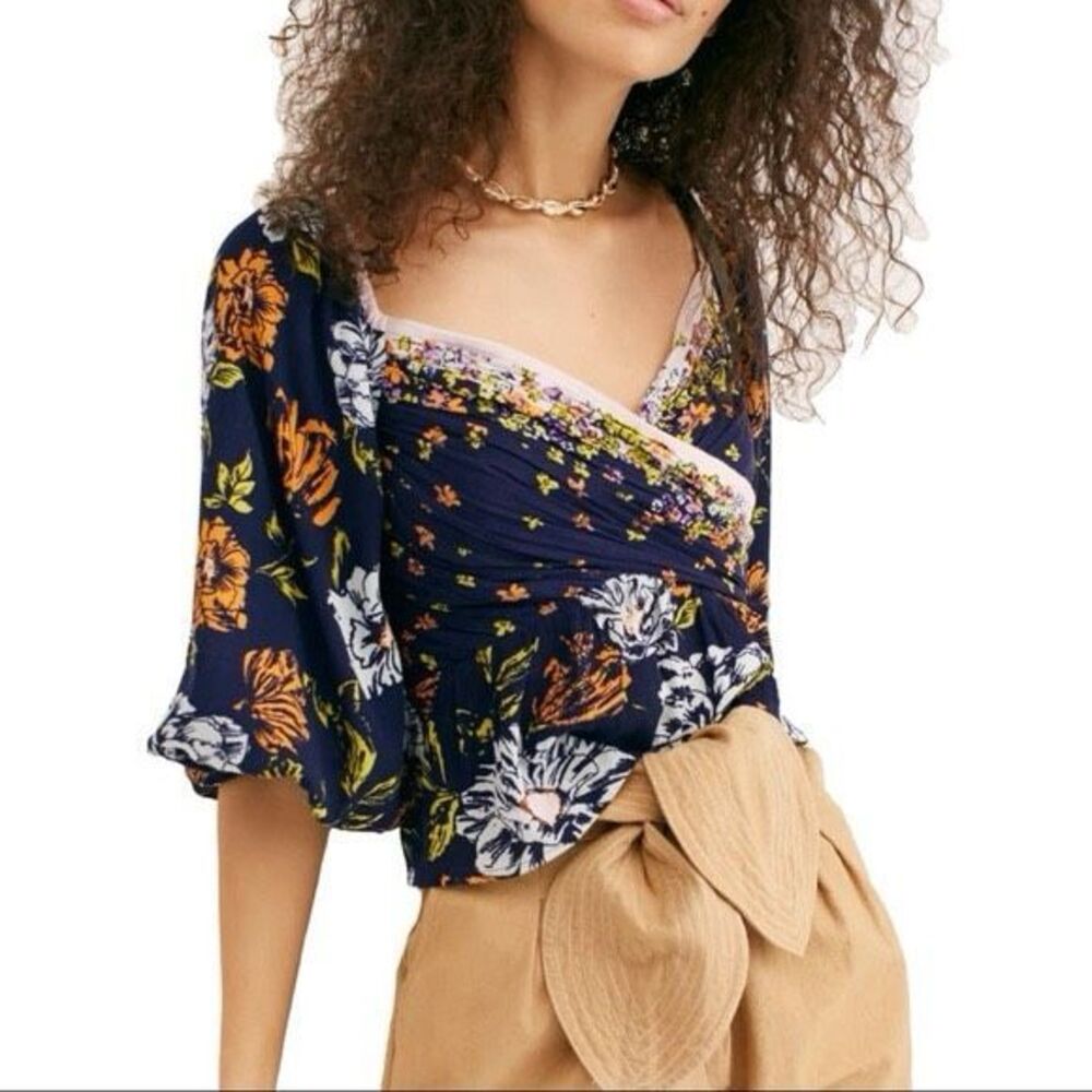 Free People Mirabella blouse featuring a blue floral print and wrap front